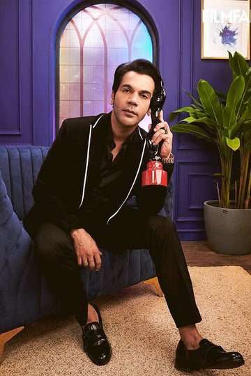 Raj Kummar Rao In Black Peak Lapel Suit With White Pipin Detail On Lapel.