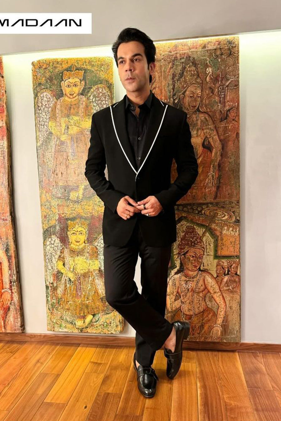 Raj Kummar Rao In Black Peak Lapel Suit With White Pipin Detail On Lapel.