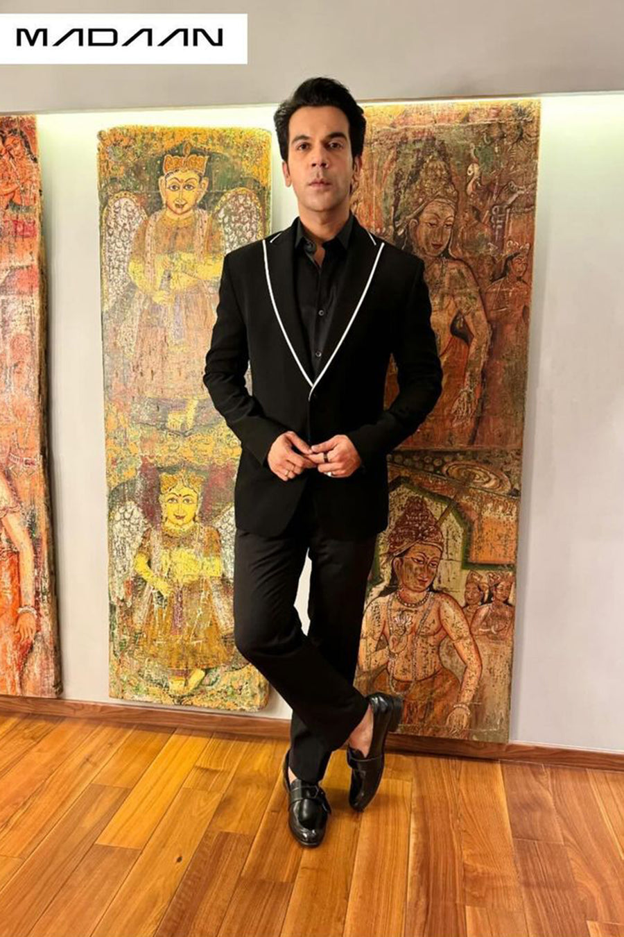 Raj Kummar Rao In Black Peak Lapel Suit With White Pipin Detail On Lapel.