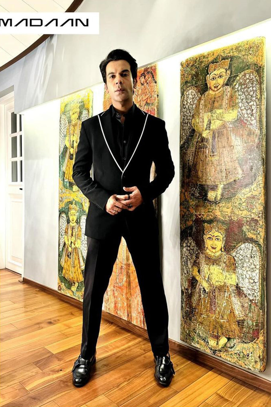 Raj Kummar Rao In Black Peak Lapel Suit With White Pipin Detail On Lapel.
